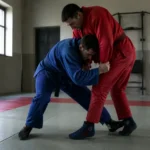 Pratique du sambo combat dans un club français, deux athlètes en action sur les tapis.